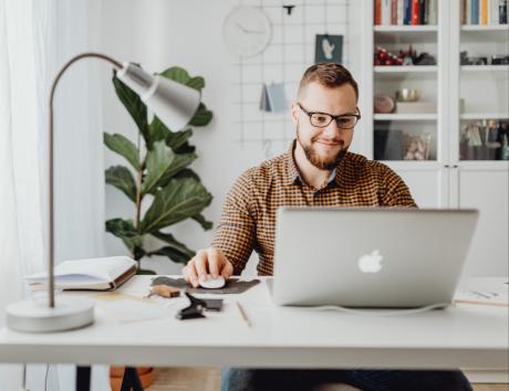 Man sitting at computer to craft an effective combination resume