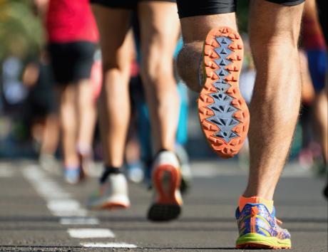 Close up of the shoes of a group of people running to illustrate hobbies and interests on your CV